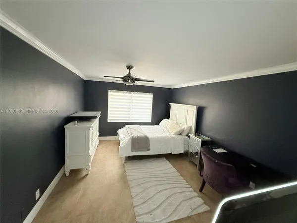 a bedroom with bed and window