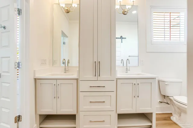 an empty room with wooden floor ceiling fan and windows