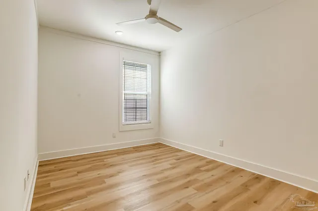 a view of a backyard with wooden fence