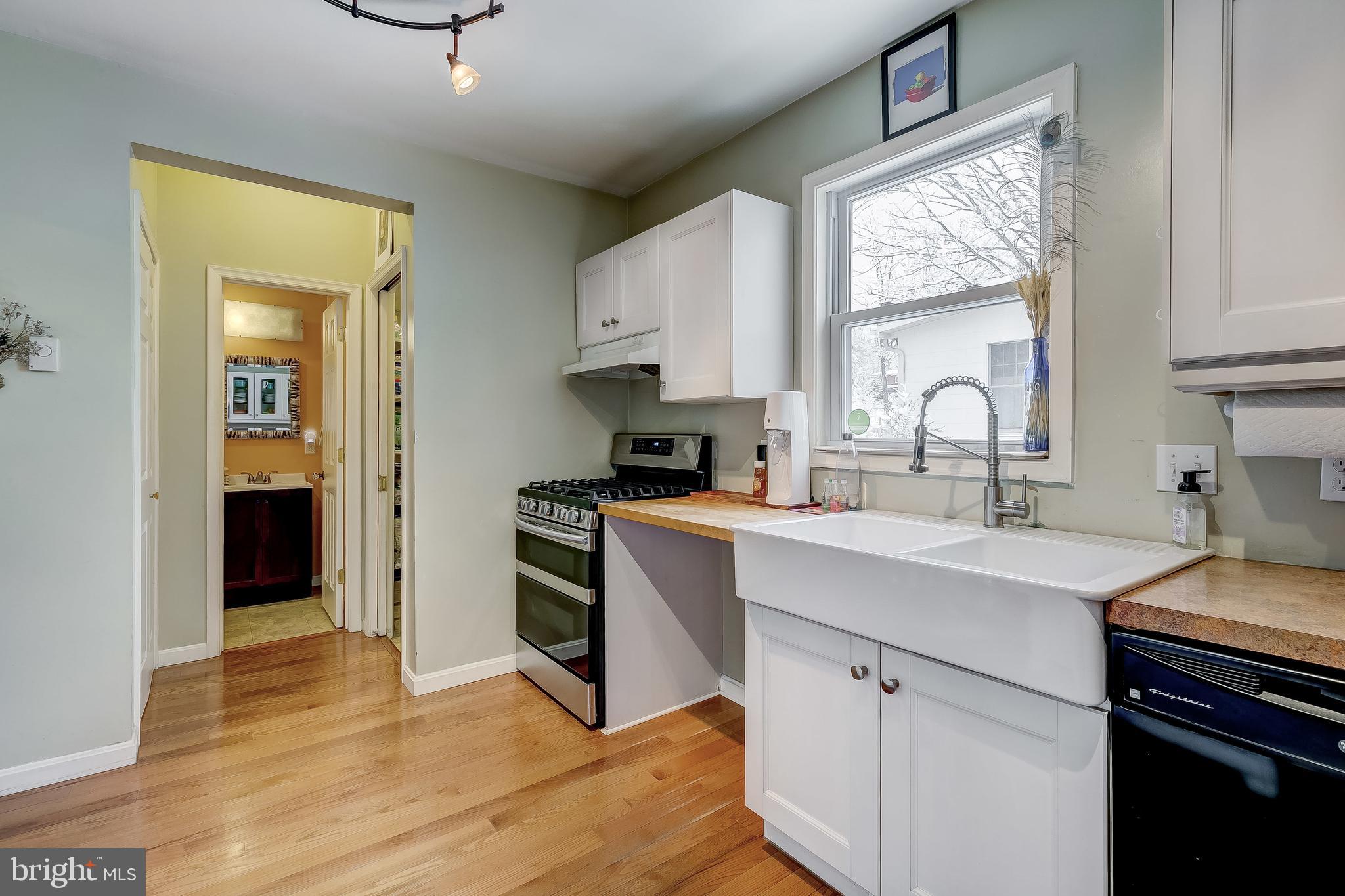 2416 Steele Road Baltimore, MD 21209 - Photo 13 of 47 a kitchen with a sink appliances cabinets and a large window