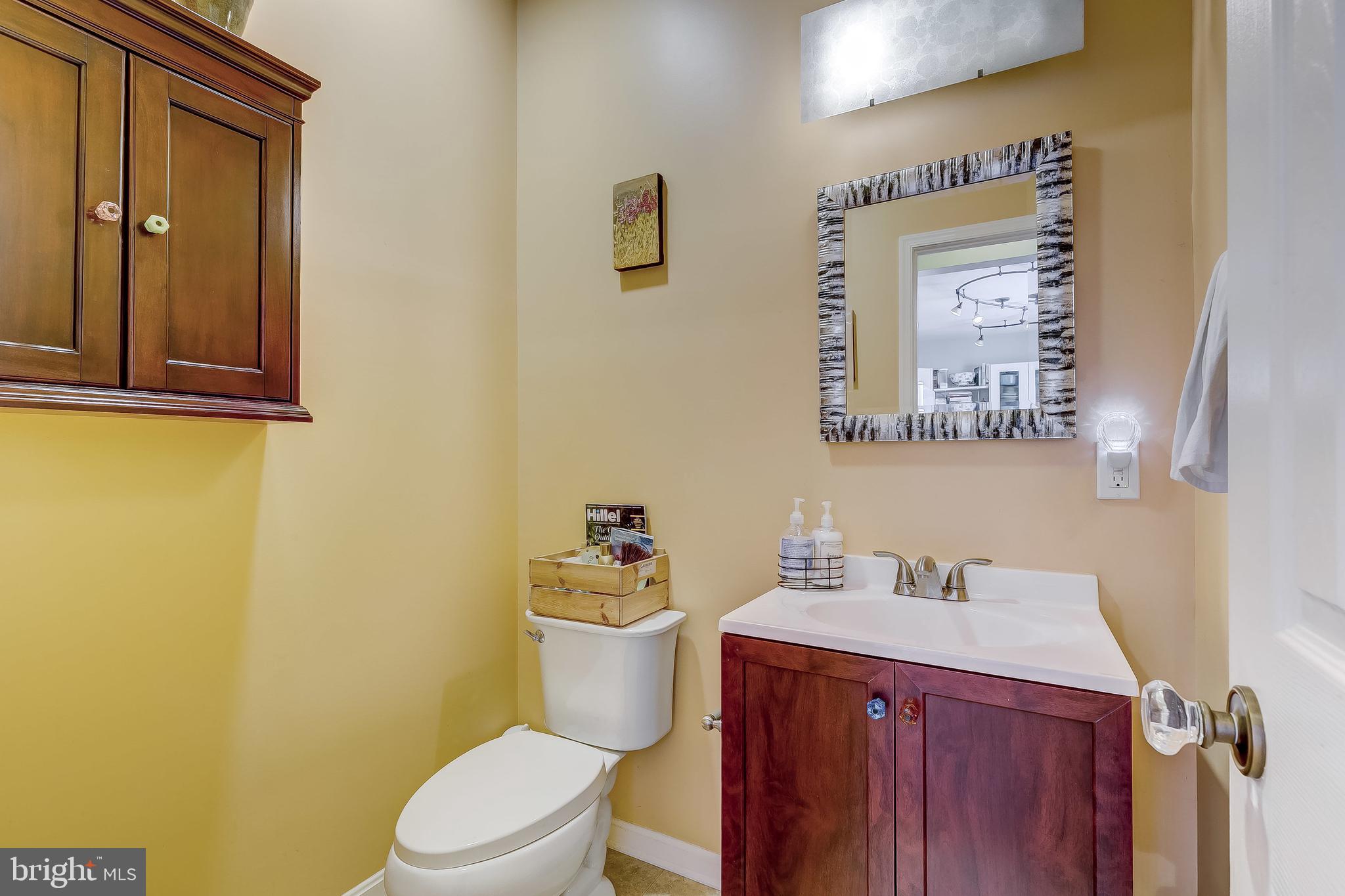 2416 Steele Road Baltimore, MD 21209 - Photo 18 of 47 a bathroom with a sink mirror vanity and toilet