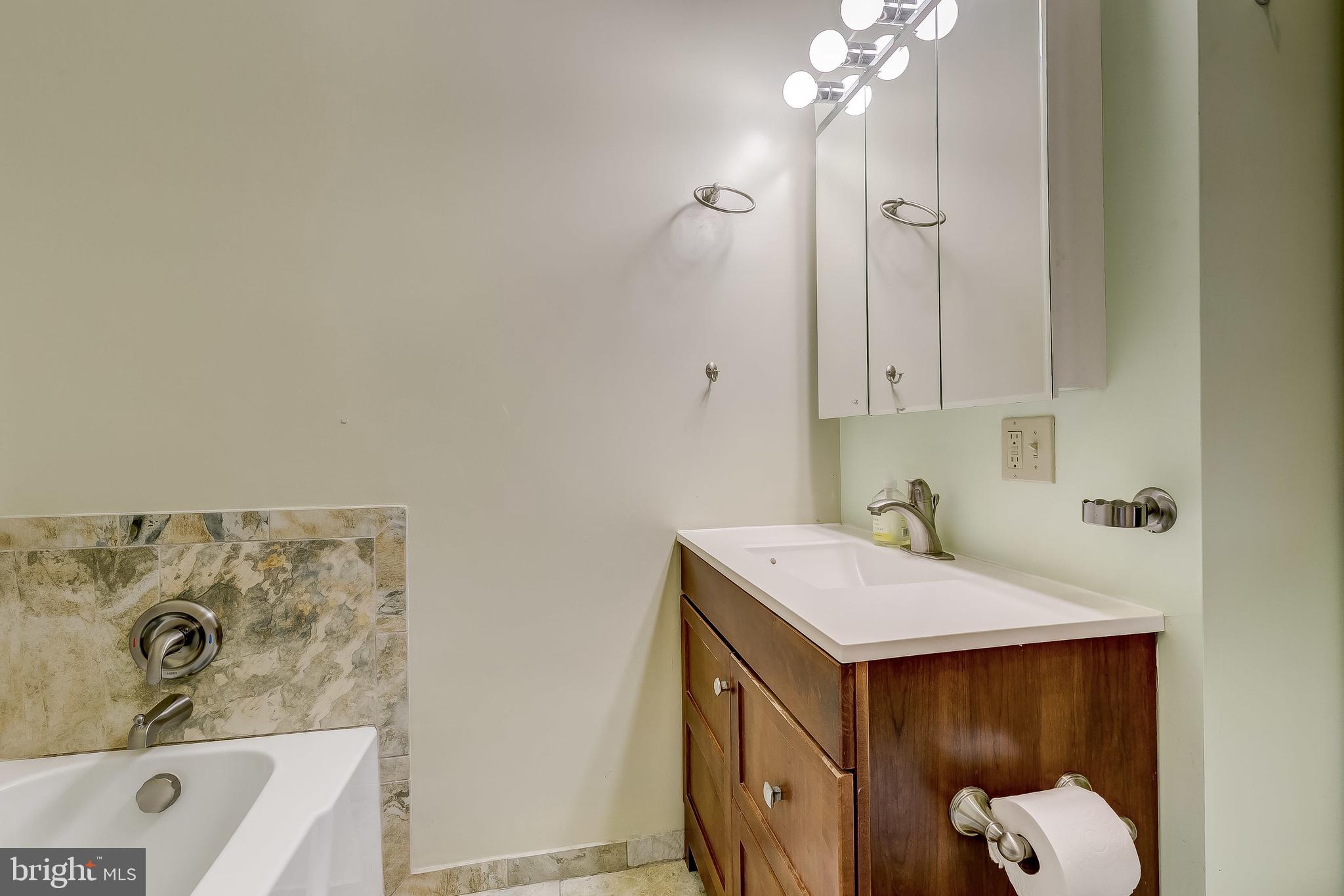 2416 Steele Road Baltimore, MD 21209 - Photo 23 of 47 a bathroom with a sink vanity and a mirror