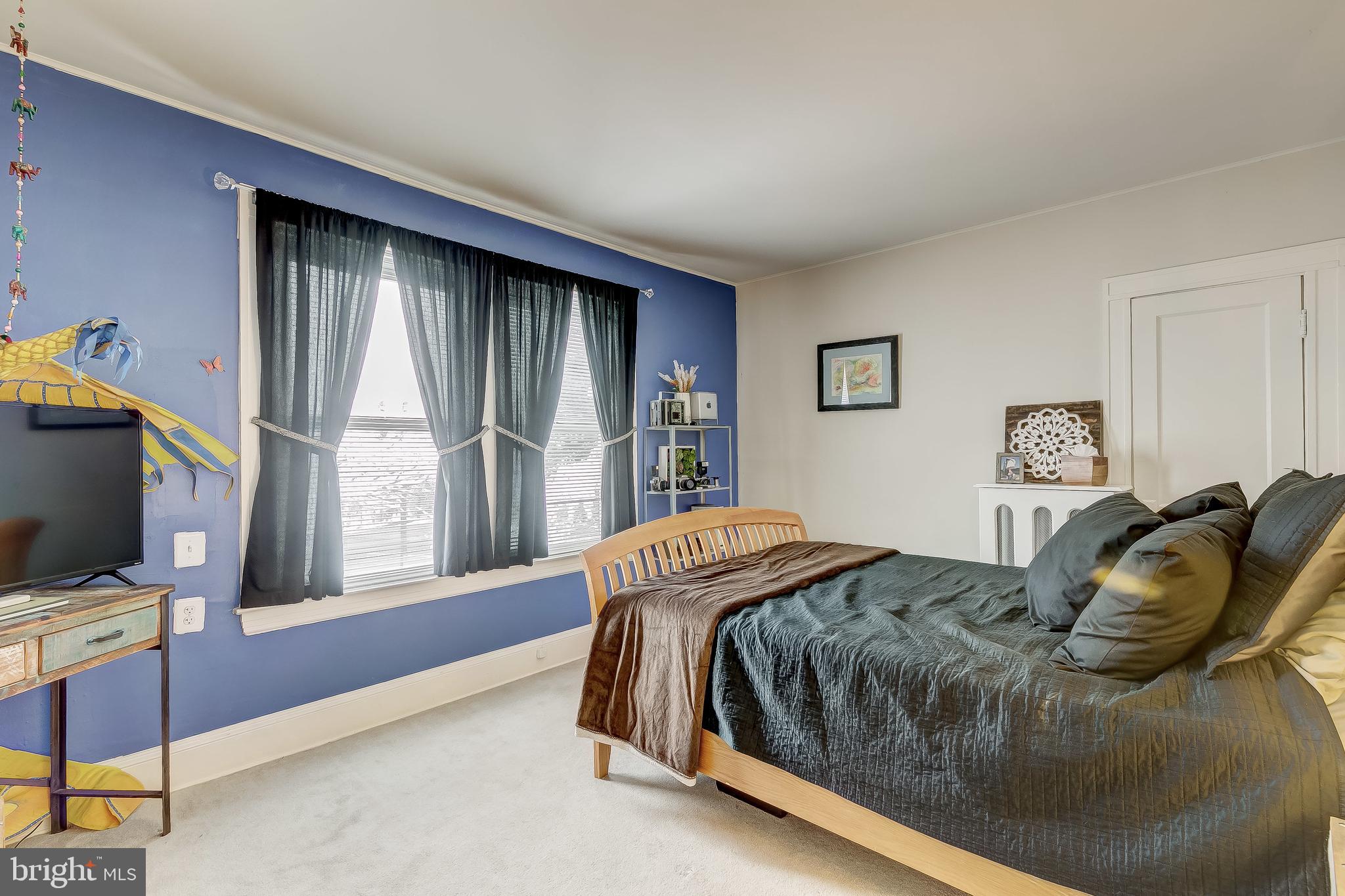 2416 Steele Road Baltimore, MD 21209 - Photo 24 of 47 a bedroom with a bed tv and window