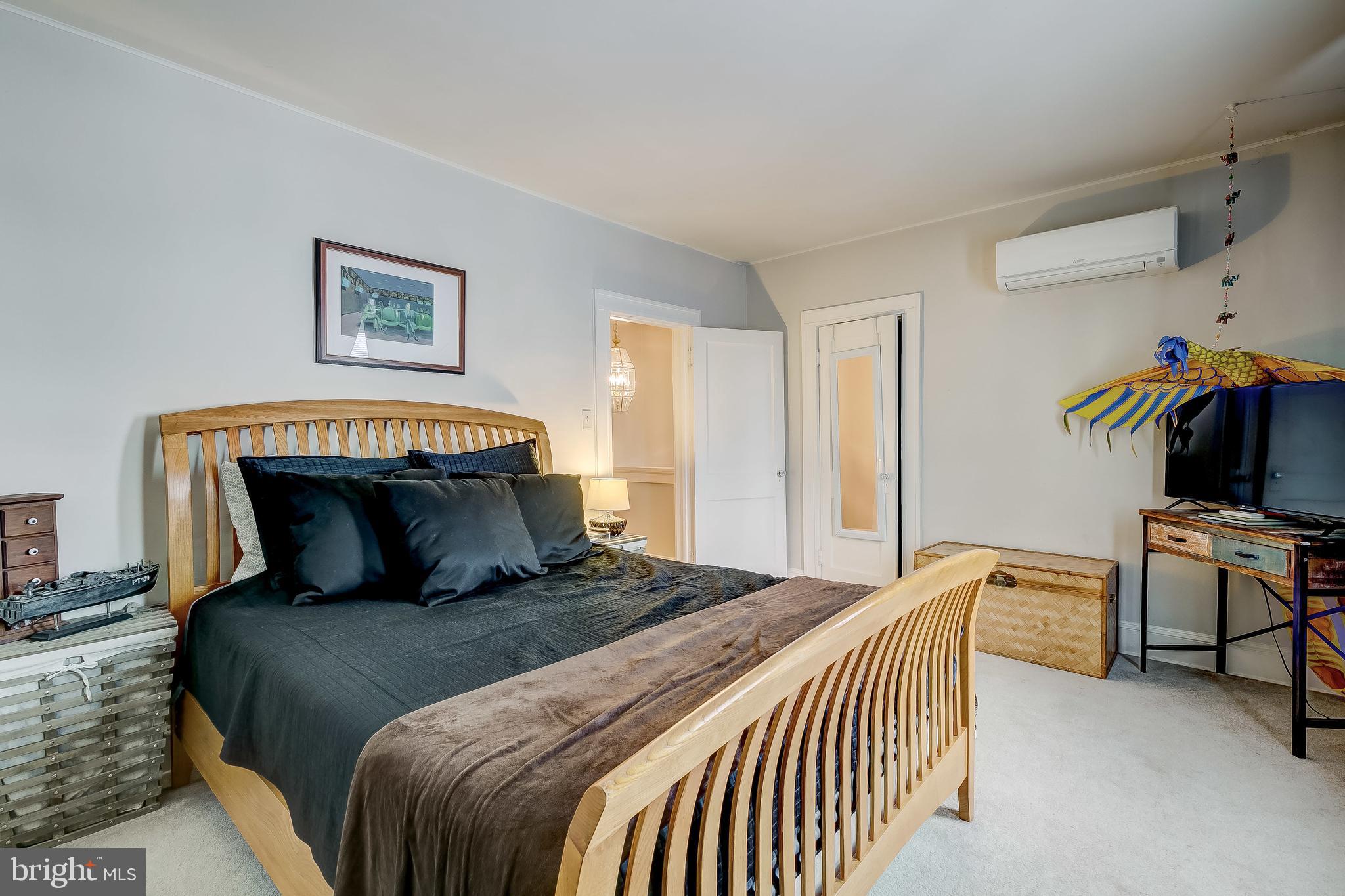 2416 Steele Road Baltimore, MD 21209 - Photo 25 of 47 a bedroom with a bed and wooden floor