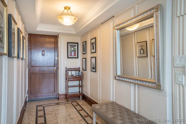 a view of a hallway with wooden floor and closet
