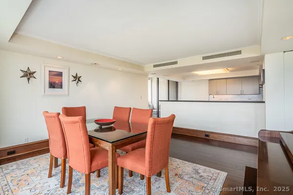 a dining room with furniture and wooden floor