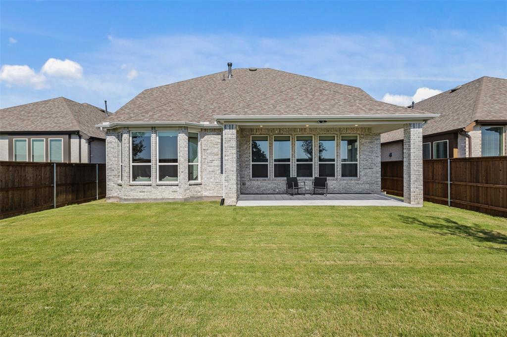 1825 Rough Rdg Trail Midlothian, TX 76065 - Photo 31 of 37 Expansive backyard featuring a lush lawn and a covered patio