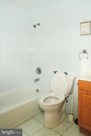 a white toilet sitting next to a bath tub