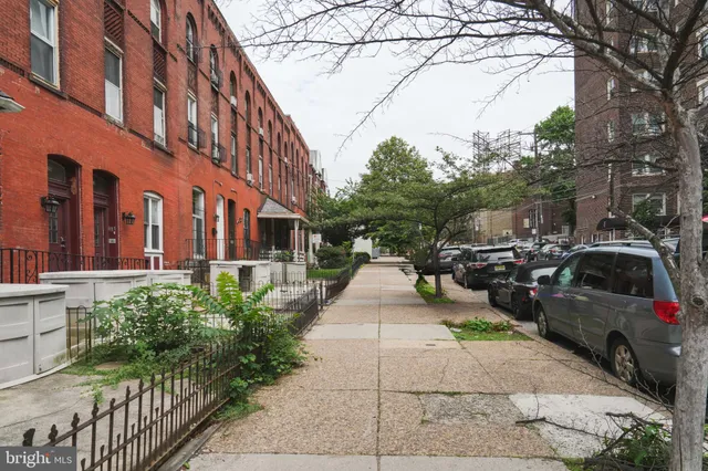 a view of a building with car parked