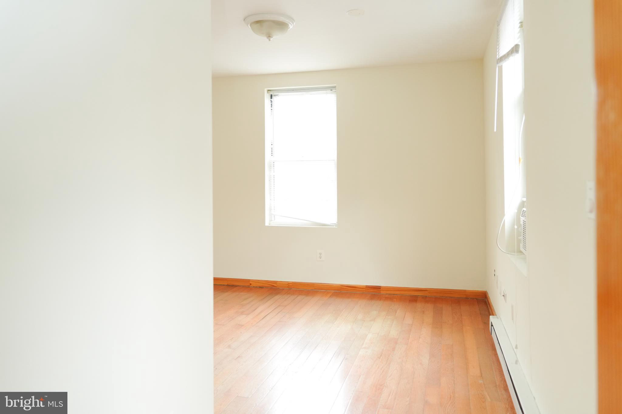 222 South 43rd Street, Unit 3 Philadelphia, PA 19104 - Photo 10 of 14 a view of a small space with wooden floor and a window