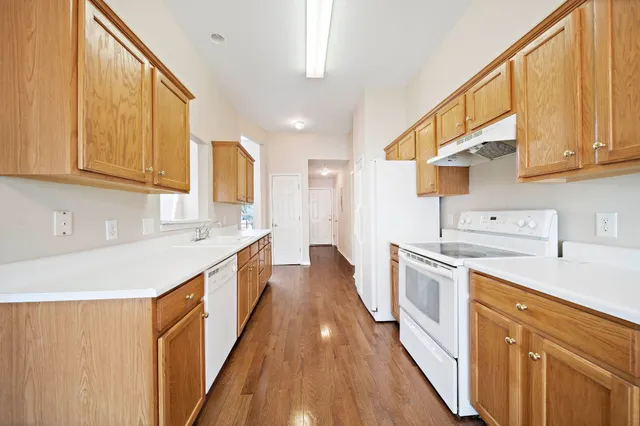 a kitchen with a sink and wooden cabinets