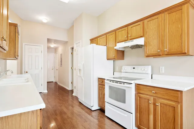 a kitchen with white cabinets and white appliances