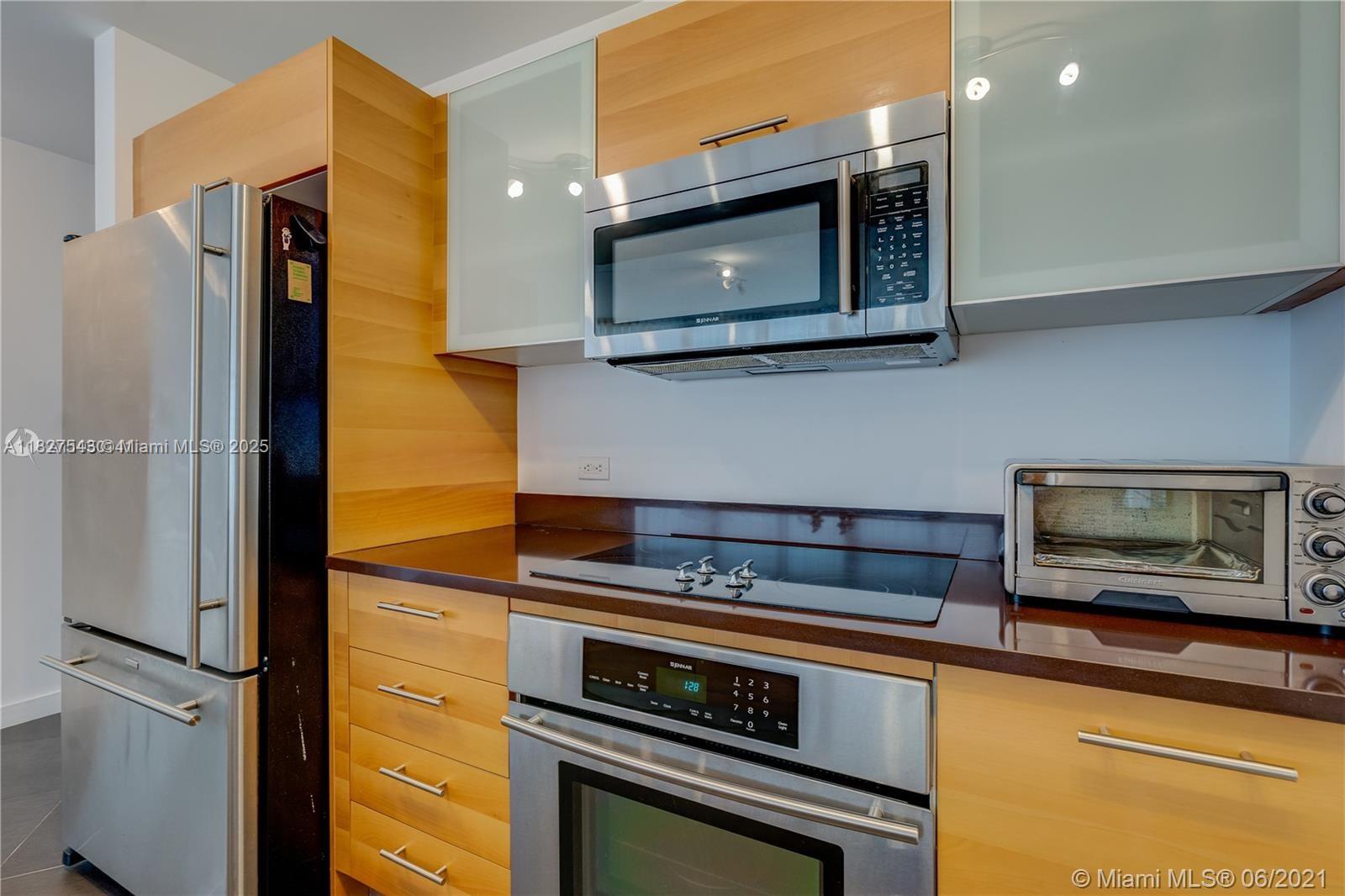3301 Northeast 1st Avenue, Unit H2009 Miami, FL 33137 - Photo 11 of 45 a kitchen with stainless steel appliances a stove microwave and sink