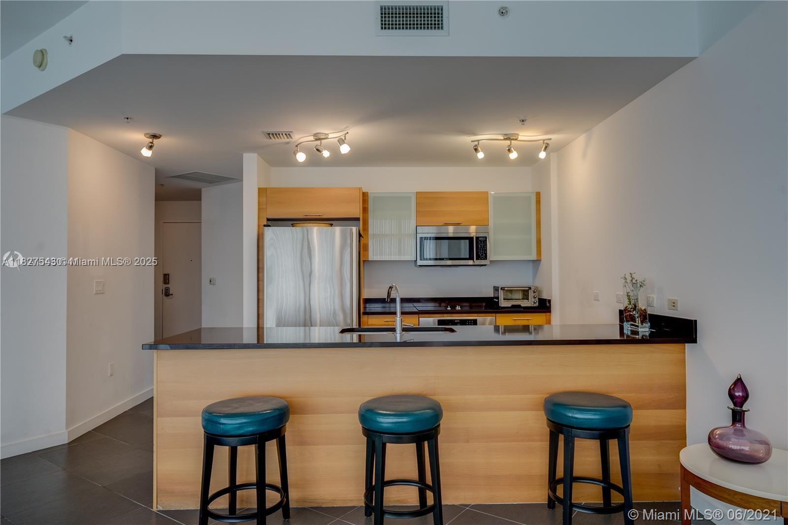 3301 Northeast 1st Avenue, Unit H2009 Miami, FL 33137 - Photo 13 of 45 a kitchen with stainless steel appliances a sink and a refrigerator