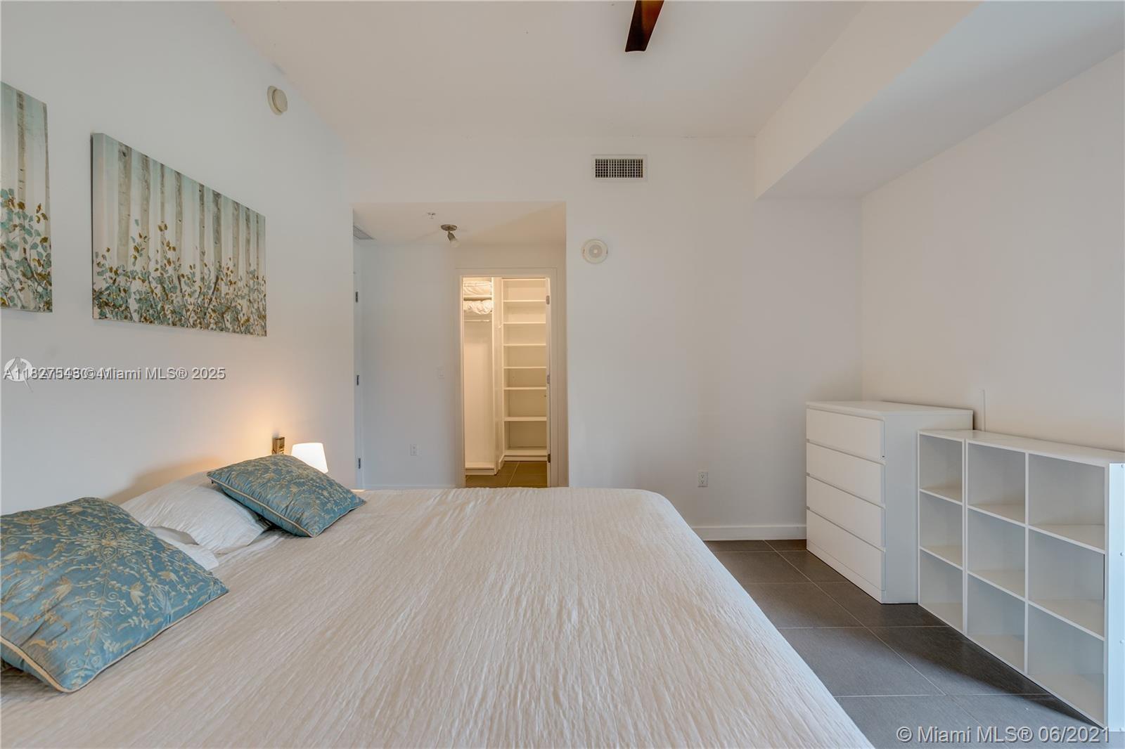 3301 Northeast 1st Avenue, Unit H2009 Miami, FL 33137 - Photo 17 of 45 a bedroom with a bed and walk in closet