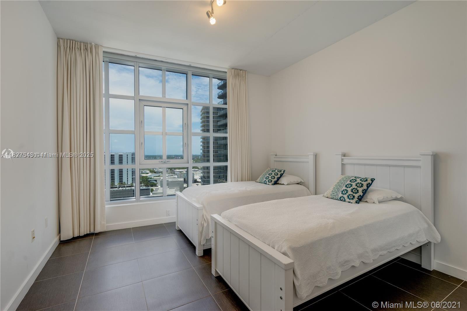 3301 Northeast 1st Avenue, Unit H2009 Miami, FL 33137 - Photo 22 of 45 a bedroom with a large bed and a large window