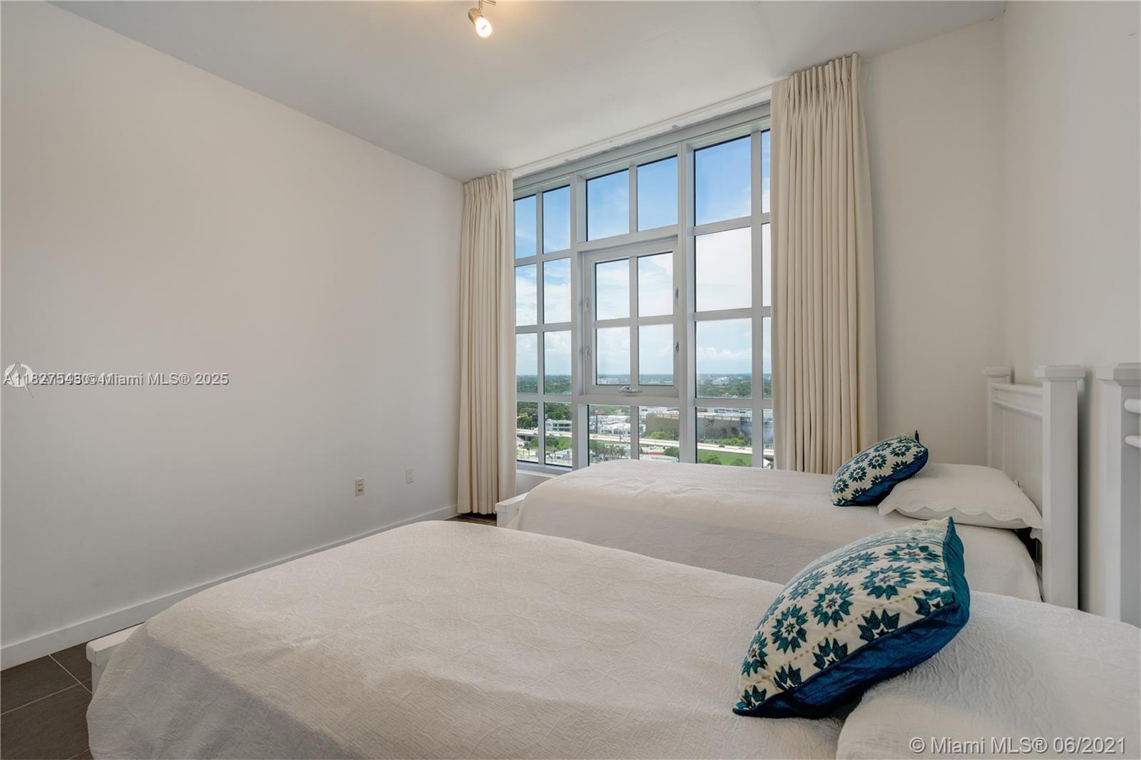 3301 Northeast 1st Avenue, Unit H2009 Miami, FL 33137 - Photo 23 of 45 a bedroom with a bed and a large window