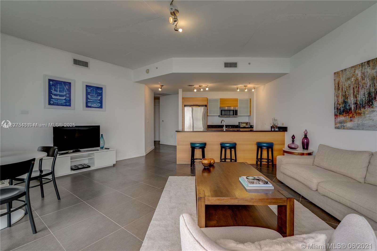 3301 Northeast 1st Avenue, Unit H2009 Miami, FL 33137 - Photo 4 of 45 a living room with furniture and a flat screen tv