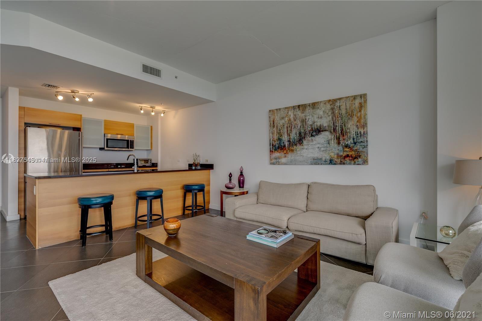 3301 Northeast 1st Avenue, Unit H2009 Miami, FL 33137 - Photo 7 of 45 a living room with furniture and a wooden floor