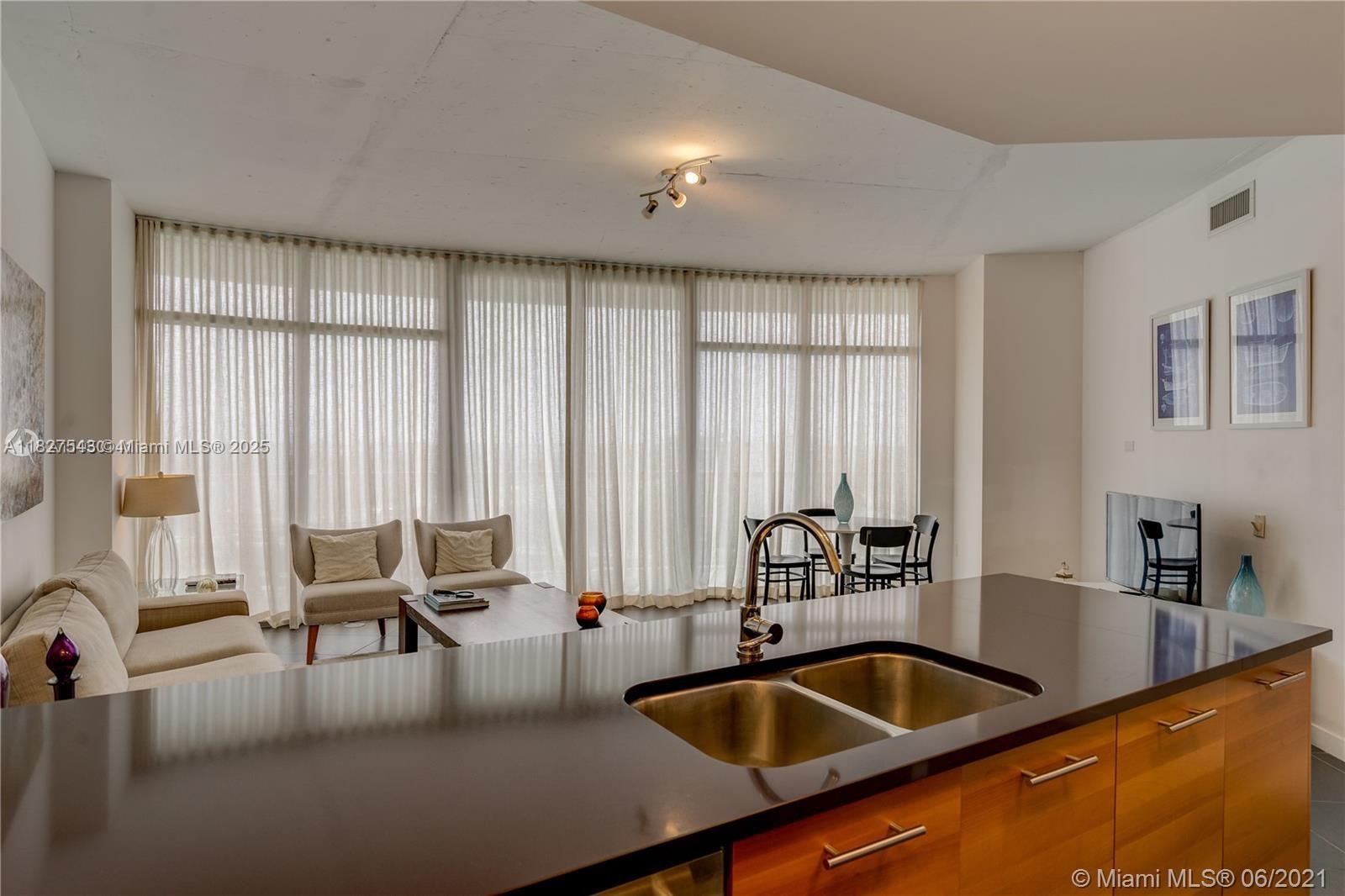3301 Northeast 1st Avenue, Unit H2009 Miami, FL 33137 - Photo 8 of 45 a kitchen with granite countertop a sink and white cabinets
