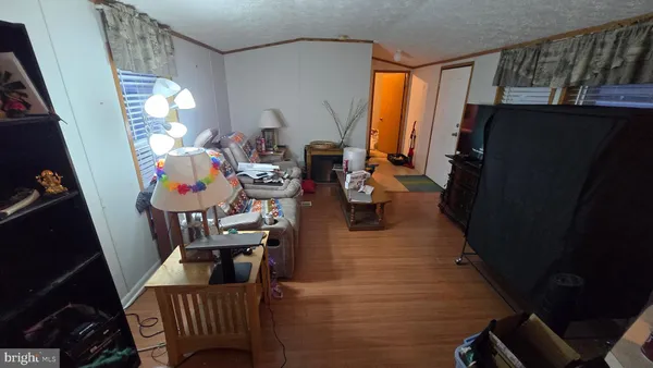 a view of a livingroom with furniture hardwood floor and a window