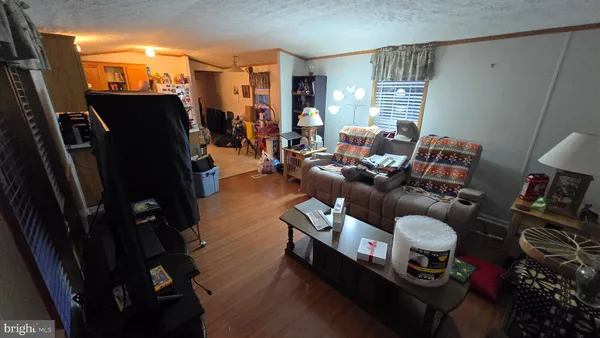a living room with furniture a flat screen tv and a window
