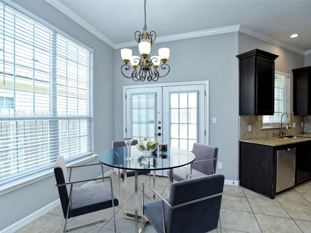 217 Geode Lane Jarrell, TX 76537 - Photo 11 of 35 Dining room featuring crown molding, light tile flooring, a chandelier, and French doors
