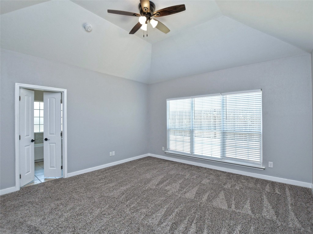 217 Geode Lane Jarrell, TX 76537 - Photo 20 of 35 Bedroom featuring carpet flooring, vaulted ceiling, and a ceiling fan
