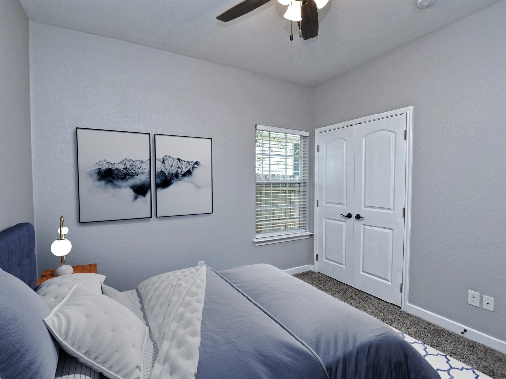 217 Geode Lane Jarrell, TX 76537 - Photo 26 of 35 Bedroom 2 carpeted featuring a closet and ceiling fan