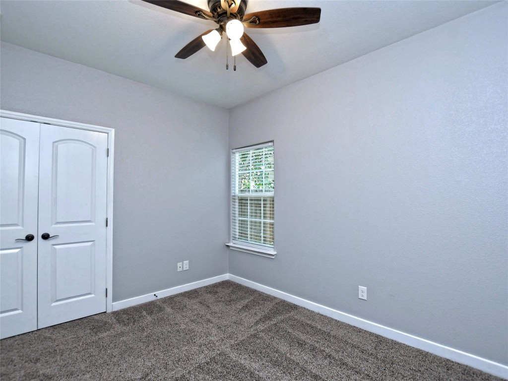 217 Geode Lane Jarrell, TX 76537 - Photo 30 of 35 Bedroom 3 with carpet flooring, a closet, and ceiling fan