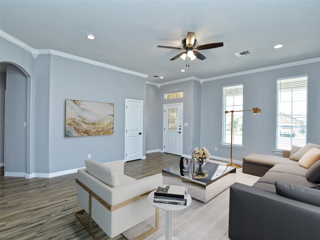 217 Geode Lane Jarrell, TX 76537 - Photo 8 of 35 Living area featuring ornamental molding, arched walkways, recessed lighting, wood finished floors, and ceiling fan