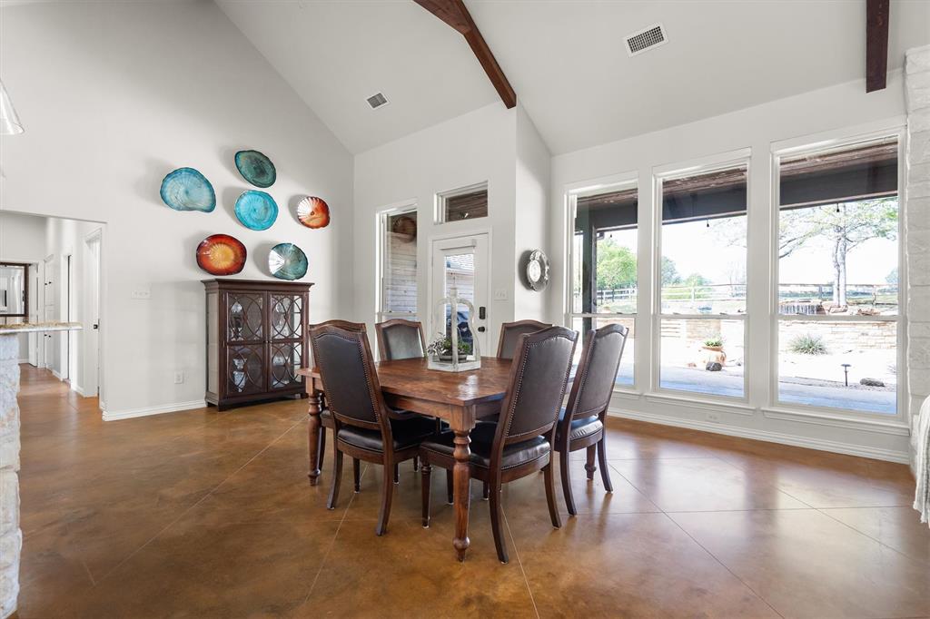 2431 Dr Sanders Road Cross Roads, TX 76227 - Photo 12 of 40 a view of a dining room with furniture a chandelier and wooden floor