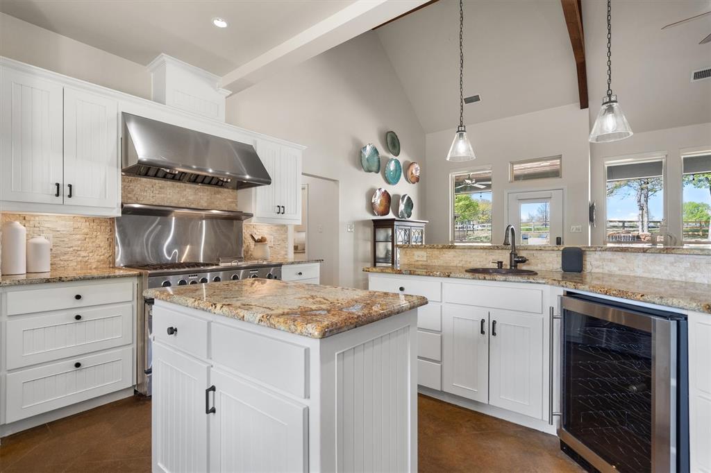 2431 Dr Sanders Road Cross Roads, TX 76227 - Photo 14 of 40 a kitchen that has a lot of cabinets in it