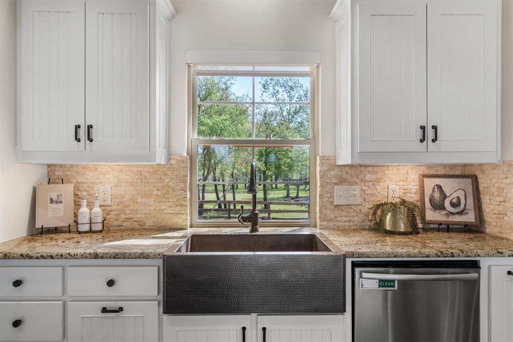 2431 Dr Sanders Road Cross Roads, TX 76227 - Photo 15 of 40 a kitchen with granite countertop a sink and a stove