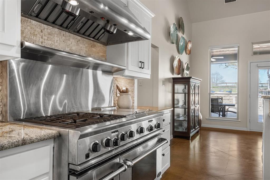 2431 Dr Sanders Road Cross Roads, TX 76227 - Photo 16 of 40 a stove top oven sitting inside of a kitchen