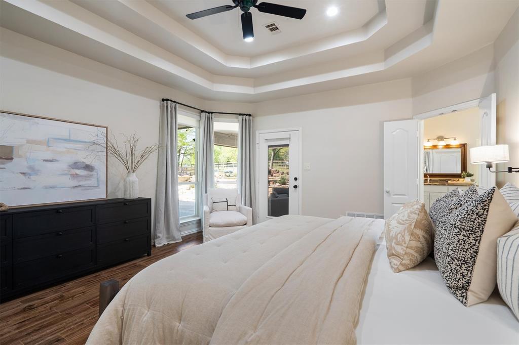 2431 Dr Sanders Road Cross Roads, TX 76227 - Photo 18 of 40 a bedroom with a bed and wooden floor