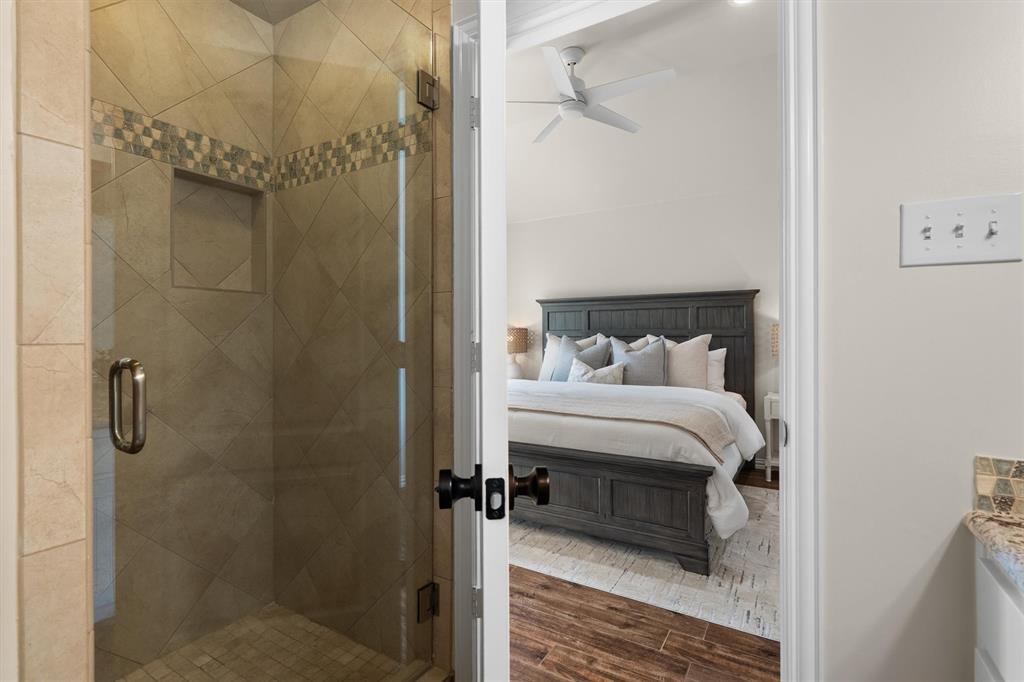 2431 Dr Sanders Road Cross Roads, TX 76227 - Photo 21 of 40 a bedroom with a bed and a shower