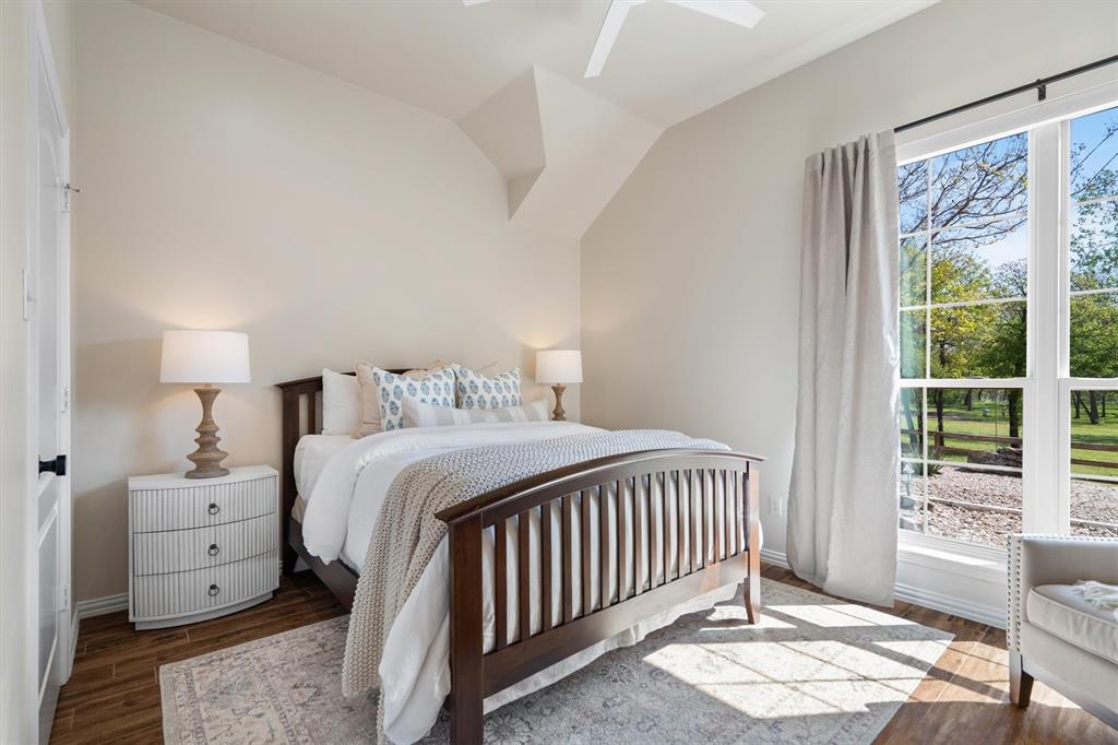2431 Dr Sanders Road Cross Roads, TX 76227 - Photo 23 of 40 a bedroom with a bed and a window