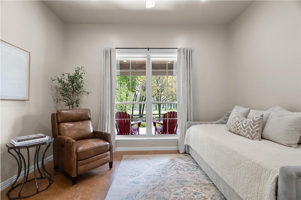 2431 Dr Sanders Road Cross Roads, TX 76227 - Photo 24 of 40 a bedroom with a bed and a couch next to a window