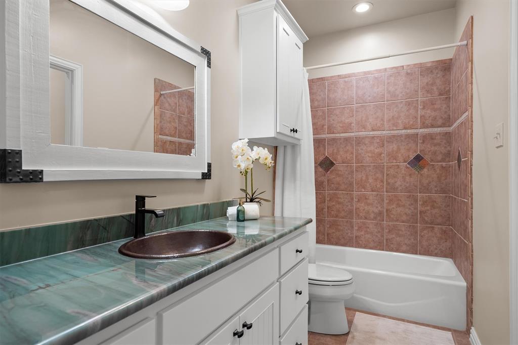 2431 Dr Sanders Road Cross Roads, TX 76227 - Photo 25 of 40 a bathroom with a sink a toilet and shower