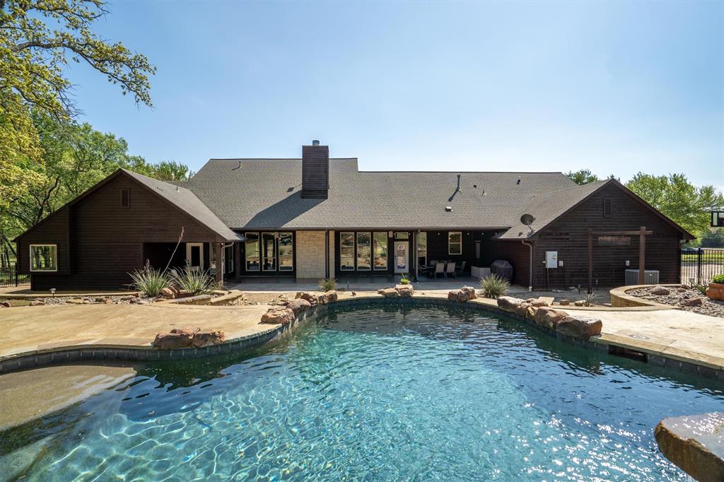 2431 Dr Sanders Road Cross Roads, TX 76227 - Photo 29 of 40 a house view with a sitting space and wooden deck