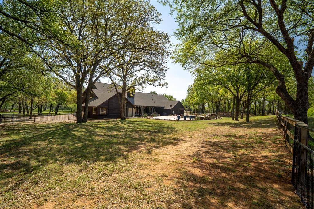 2431 Dr Sanders Road Cross Roads, TX 76227 - Photo 31 of 40 a view of a large garden with large trees