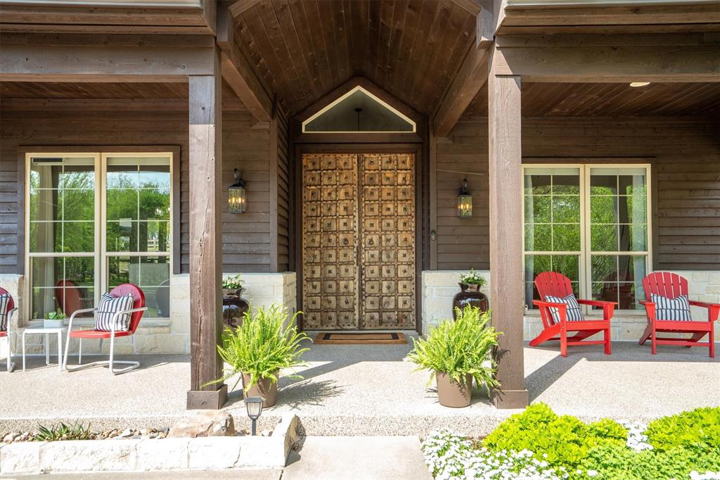 2431 Dr Sanders Road Cross Roads, TX 76227 - Photo 5 of 40 a potted plant sitting in front of a house
