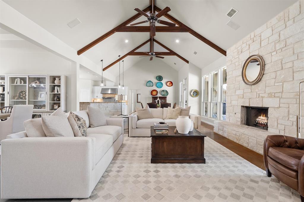 2431 Dr Sanders Road Cross Roads, TX 76227 - Photo 8 of 40 a living room with furniture a fireplace and a ceiling fan