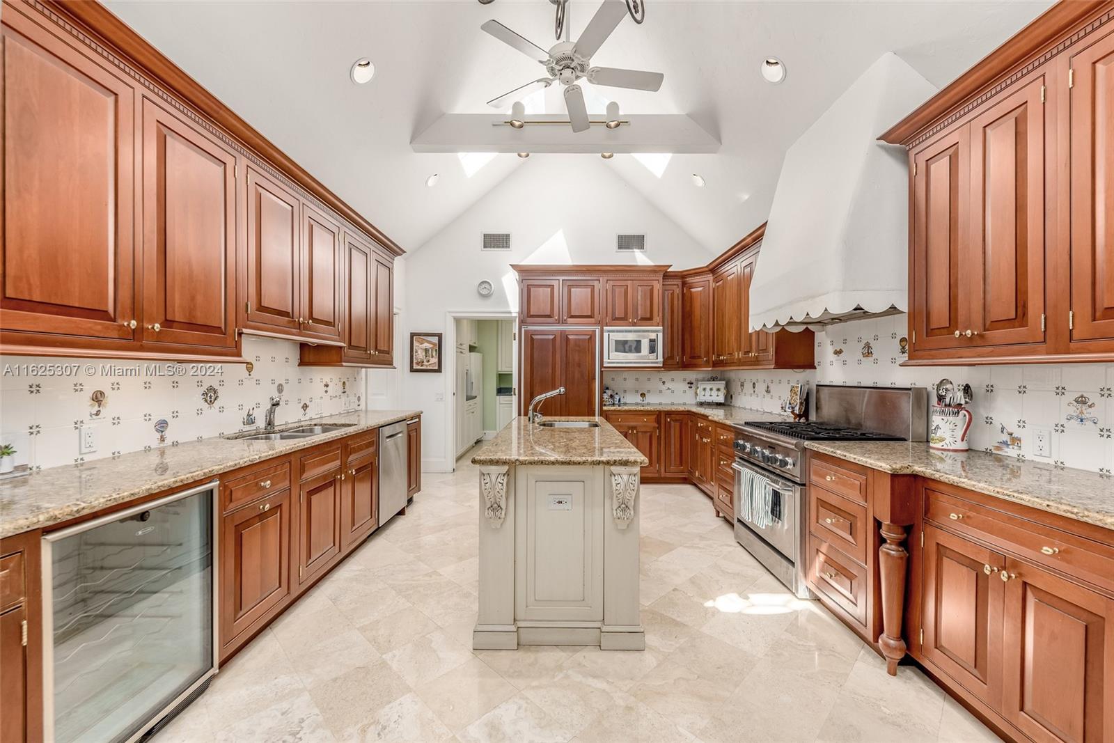 43 North Beach Road Jupiter Island, FL 33455 - Photo 15 of 34 a large kitchen with stainless steel appliances granite countertop a sink a stove and cabinets