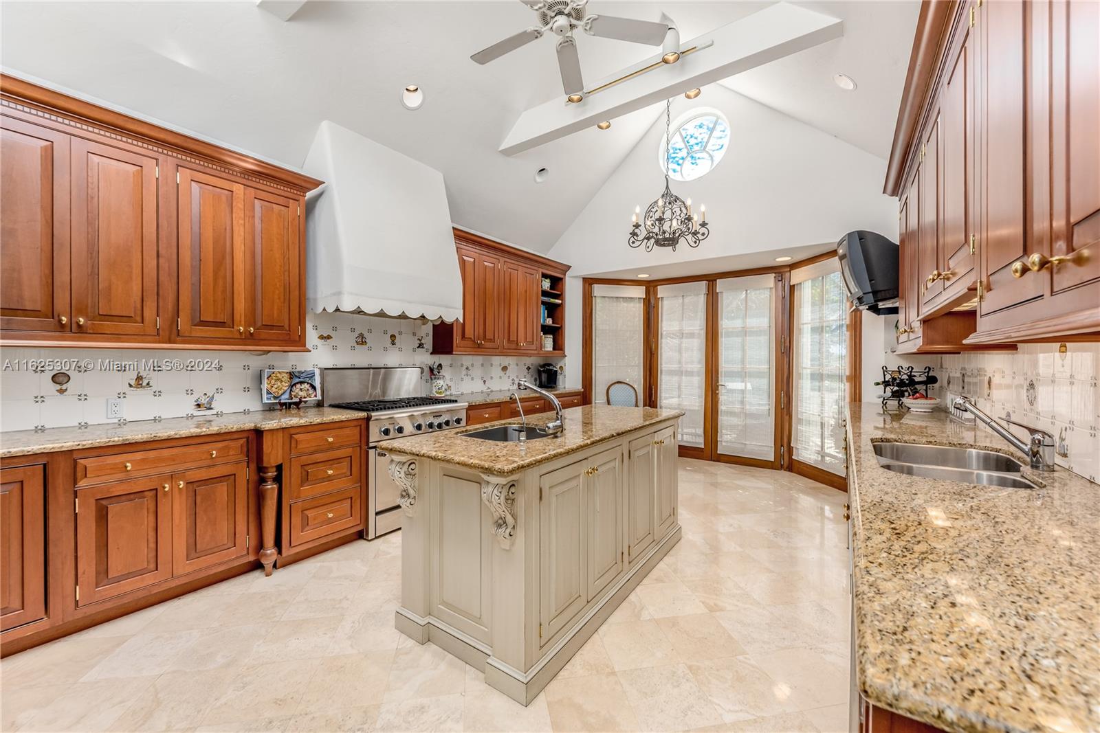 43 North Beach Road Jupiter Island, FL 33455 - Photo 16 of 34 a kitchen with stainless steel appliances granite countertop a sink stove and refrigerator