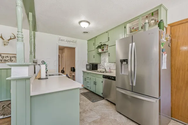 a kitchen with stainless steel appliances a refrigerator and a sink