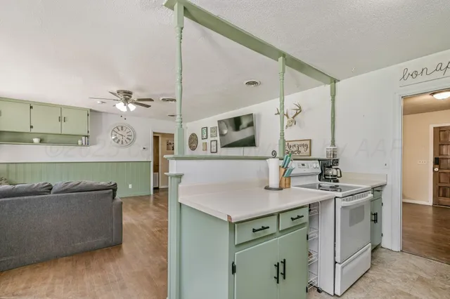 a kitchen with stainless steel appliances granite countertop a sink and a refrigerator