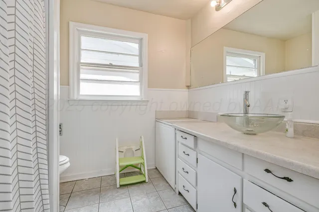 a room with a sink and cabinets