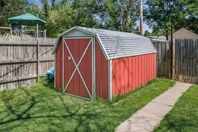 a backyard of a house with table and chairs